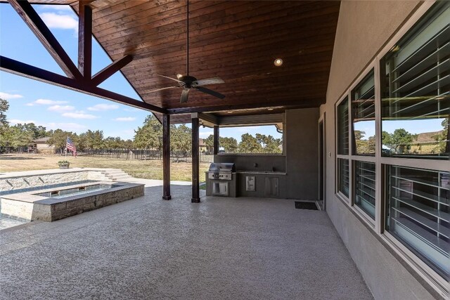 view of patio / terrace with an outdoor hot tub, a grill, an outdoor kitchen, and ceiling fan