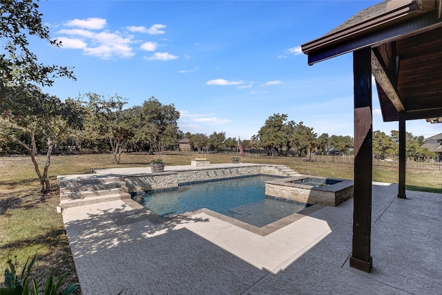 view of pool with a jacuzzi, a patio area, and a lawn