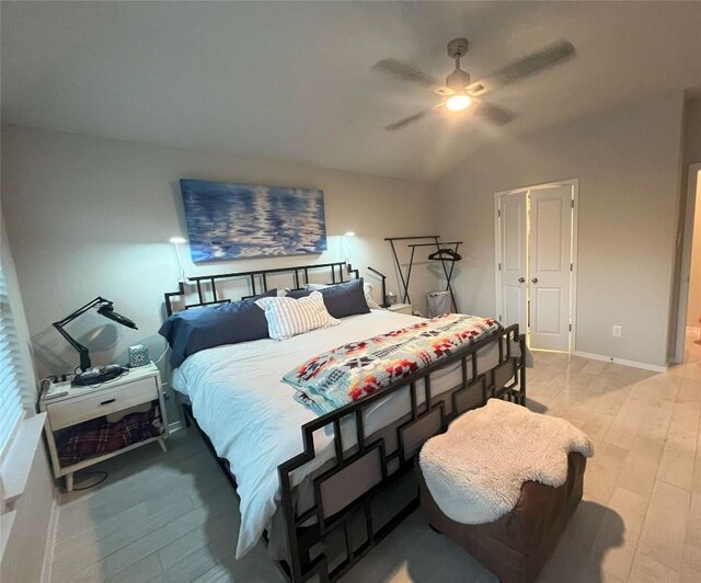 bedroom featuring lofted ceiling, ceiling fan, and light hardwood / wood-style floors