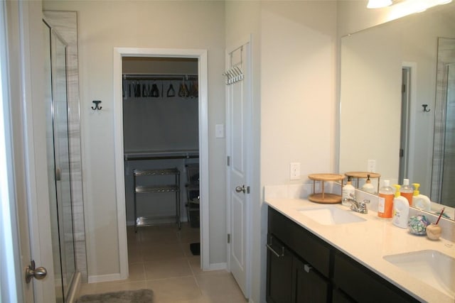 bathroom with tile patterned floors, an enclosed shower, and vanity