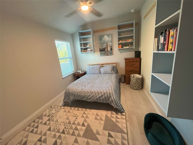 bedroom featuring lofted ceiling, light wood-type flooring, and ceiling fan