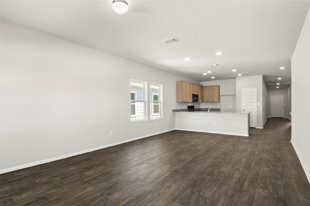204 Lavender Ln, Elgin, TX 78621 - unfurnished living room featuring dark wood finished floors and recessed lighting