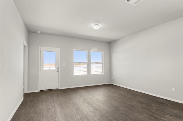 204 Lavender Ln, Elgin, TX 78621 - spare room with dark wood-style floors and baseboards