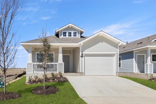 204 Lavender Ln, Elgin, TX 78621 - craftsman-style home with driveway, a garage, covered porch, a front lawn, and roof with shingles
