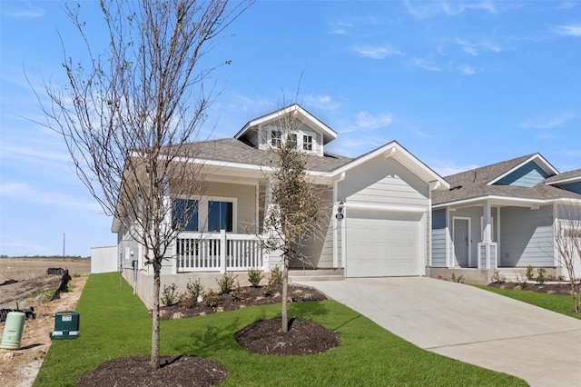 204 Lavender Ln, Elgin, TX 78621 - view of front of house featuring a garage, covered porch, concrete driveway, a front yard, and a shingled roof
