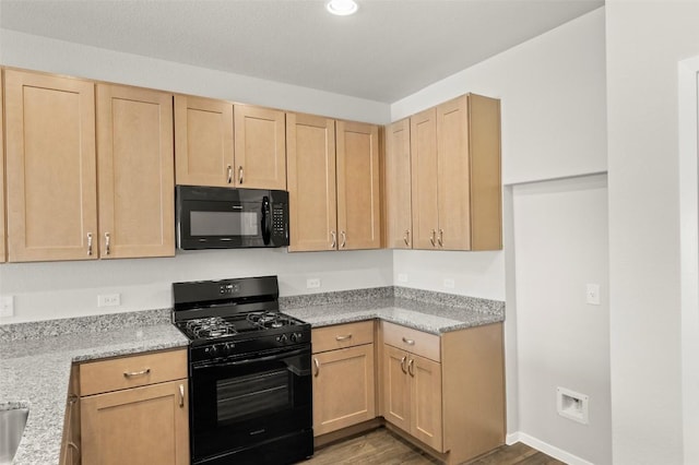 204 Lavender Ln, Elgin, TX 78621 - kitchen with black appliances, light brown cabinets, dark wood-style floors, recessed lighting, and light stone countertops