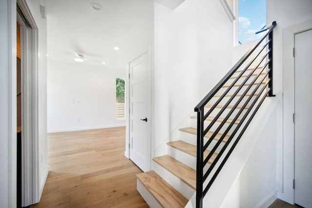 stairs with hardwood / wood-style flooring