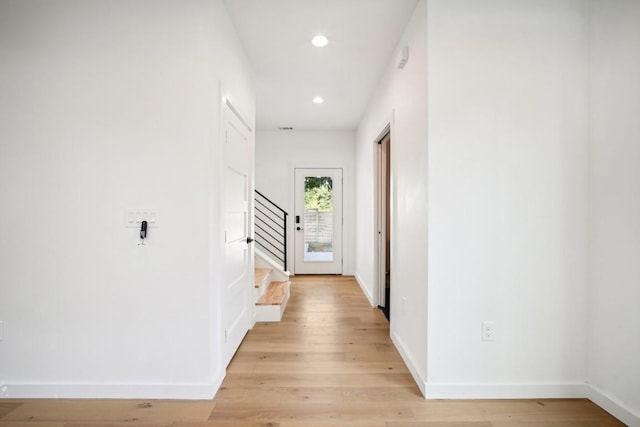 hallway with light hardwood / wood-style flooring