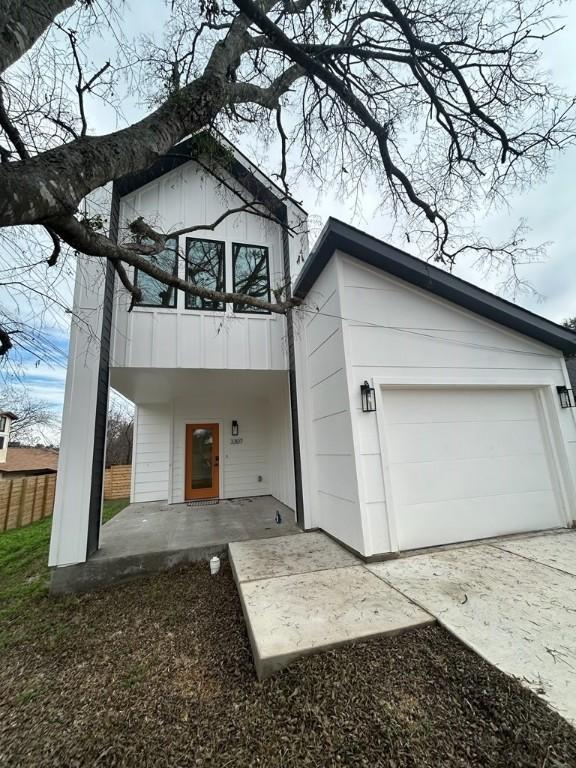 view of front of home with a garage and a balcony