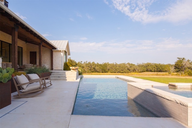 view of swimming pool with a patio area