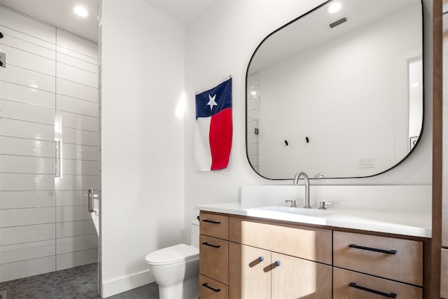 bathroom featuring vanity and toilet