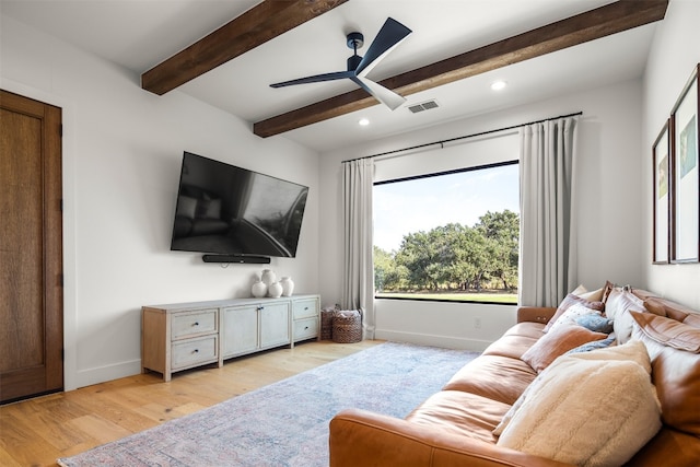 living room featuring ceiling fan, beamed ceiling, and light hardwood / wood-style floors