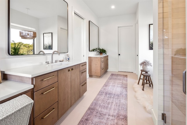 bathroom with tile patterned floors, vanity, and an enclosed shower