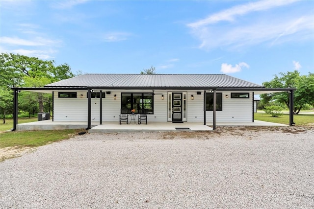 view of front of home featuring a patio and metal roof