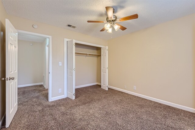 unfurnished bedroom featuring carpet flooring, a textured ceiling, a closet, and ceiling fan