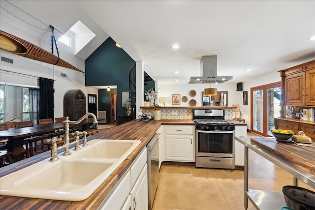 kitchen with a healthy amount of sunlight, stainless steel appliances, ventilation hood, and butcher block countertops