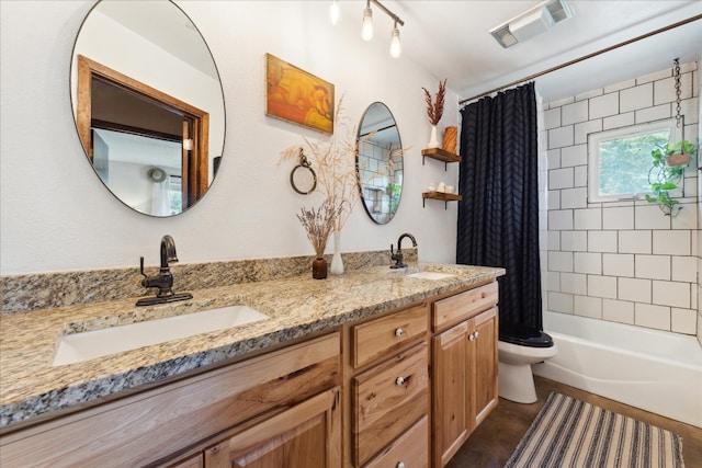 full bathroom with vanity, toilet, and shower / tub combo