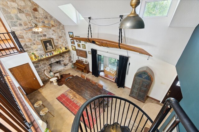 carpeted living room with a notable chandelier and high vaulted ceiling