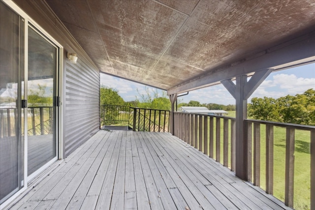 wooden terrace with a yard