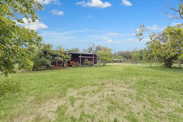 view of yard with a rural view and an outbuilding