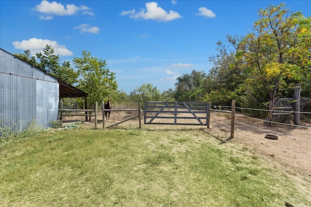 view of yard featuring a rural view and an outdoor structure