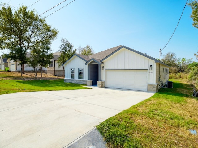 ranch-style home with cooling unit, a front lawn, and a garage