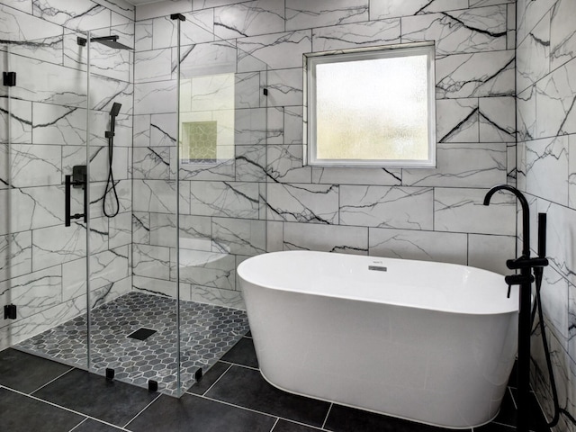 bathroom with tile walls, tile patterned floors, and separate shower and tub