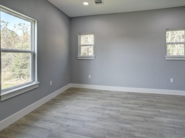 empty room with light hardwood / wood-style flooring