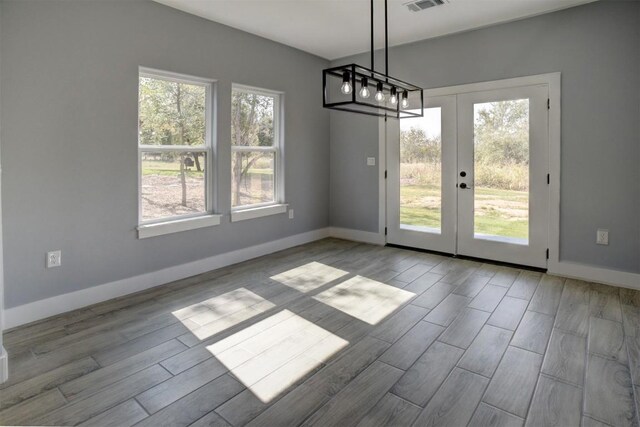 unfurnished dining area with light wood-type flooring and plenty of natural light