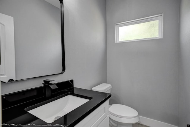 bathroom featuring toilet and vanity