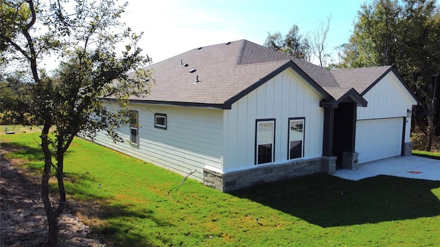 view of home's exterior with a yard and a garage