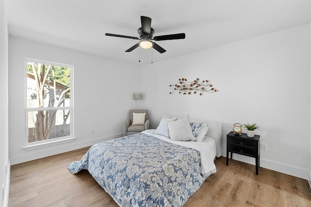 bedroom with hardwood / wood-style floors and ceiling fan