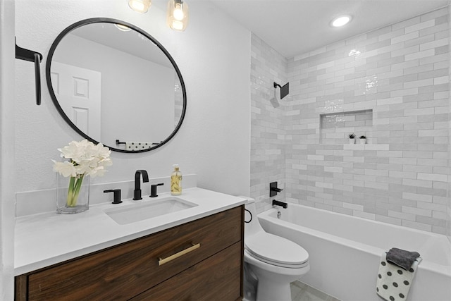 full bathroom featuring vanity, toilet, and tiled shower / bath combo