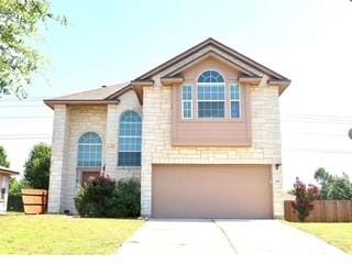 248 Coal Dr, Jarrell, TX 76537 - traditional-style home featuring driveway, fence, a front lawn, and a garage