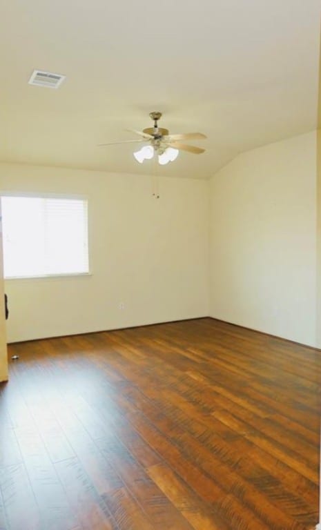 empty room with ceiling fan and dark hardwood / wood-style floors