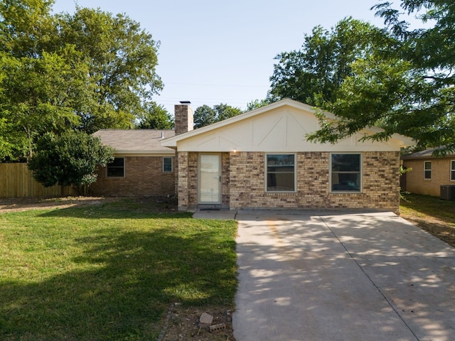 ranch-style house featuring a patio, a front lawn, and central AC unit