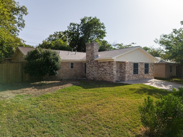 rear view of house with a lawn