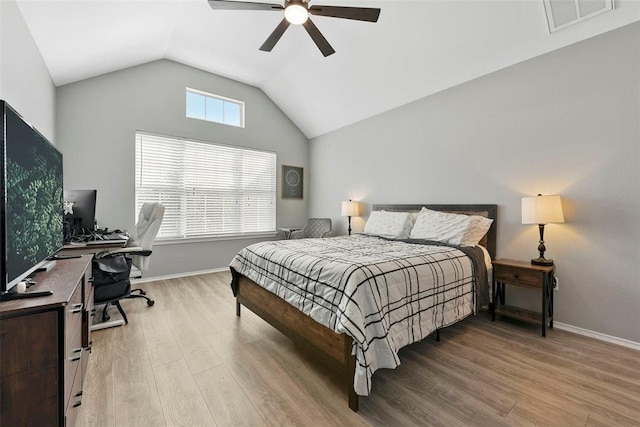 bedroom with vaulted ceiling, light hardwood / wood-style flooring, multiple windows, and ceiling fan