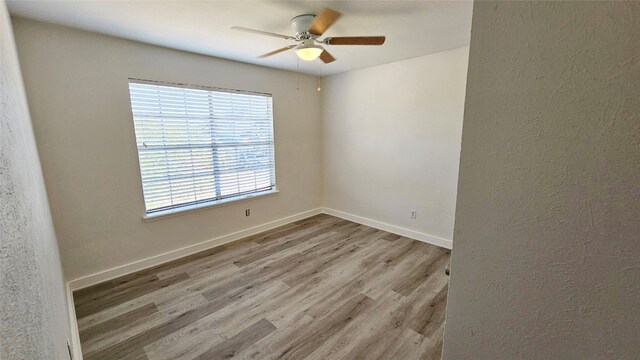 unfurnished room with ceiling fan and light hardwood / wood-style flooring