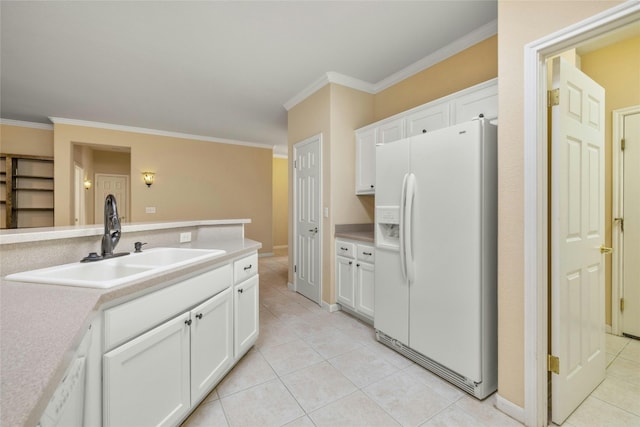 kitchen featuring sink, white refrigerator with ice dispenser, white cabinetry, crown molding, and light tile patterned floors