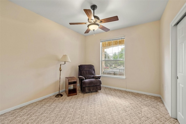 sitting room with ceiling fan and carpet flooring