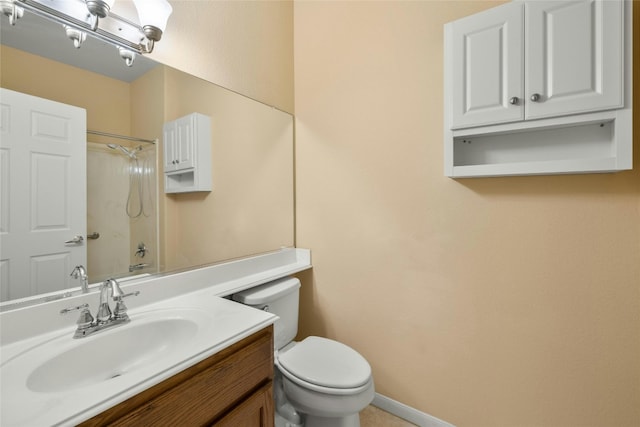 bathroom with vanity, toilet, and walk in shower