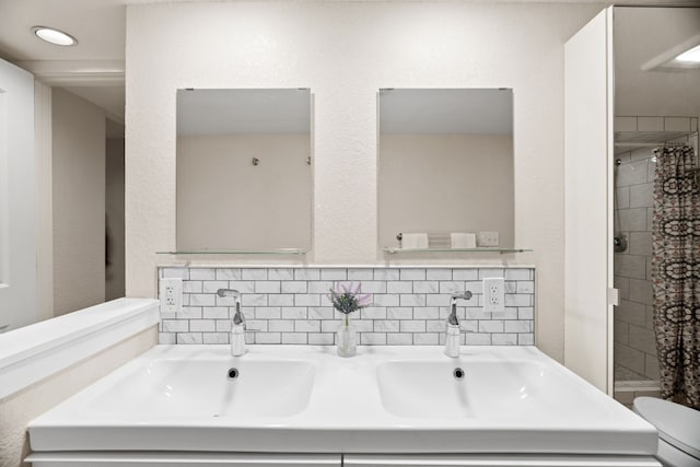 bathroom featuring toilet, a shower with curtain, vanity, and backsplash