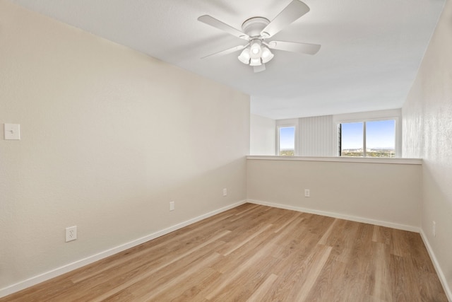 spare room with light hardwood / wood-style flooring and ceiling fan