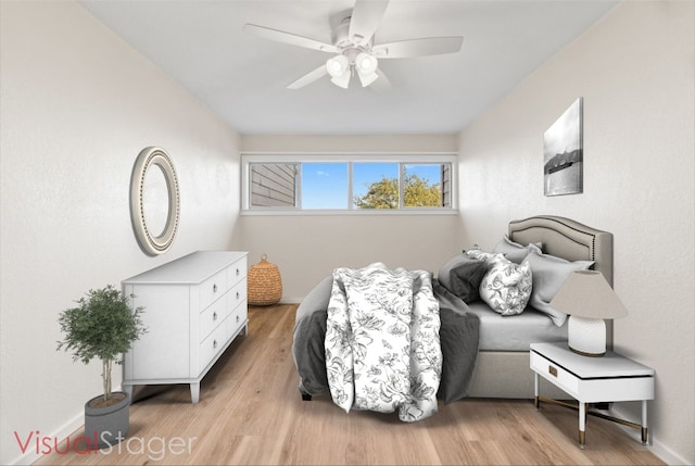 bedroom with light hardwood / wood-style floors and ceiling fan