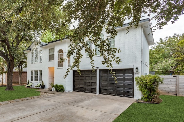 view of front of property featuring a front yard and a garage