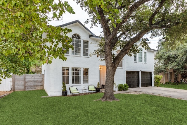 view of front facade featuring a front yard and a garage