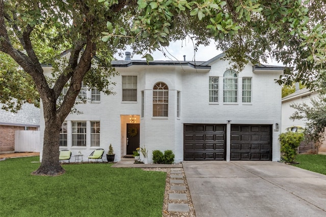 view of front of home featuring a garage and a front lawn