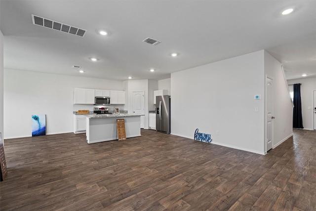 11104 Roving Pass, Elgin, TX 78621 - kitchen featuring dark wood finished floors, visible vents, open floor plan, and appliances with stainless steel finishes