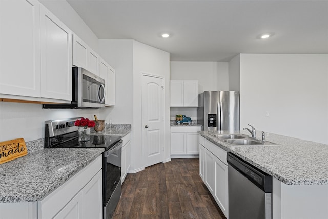 kitchen featuring white cabinets, a center island with sink, dark hardwood / wood-style flooring, sink, and stainless steel appliances